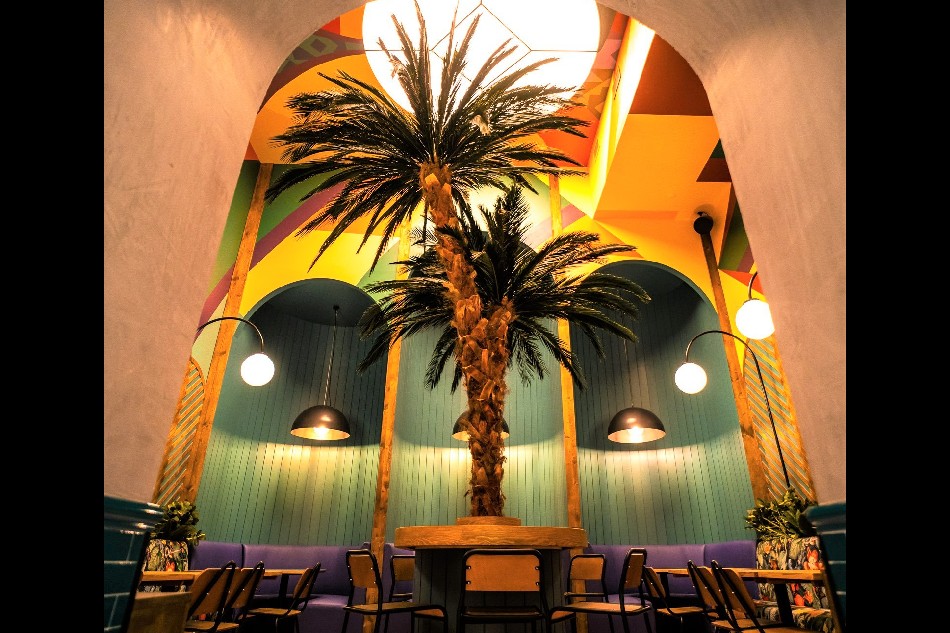 A palm tree inside Jollibee Madrid. Handout
