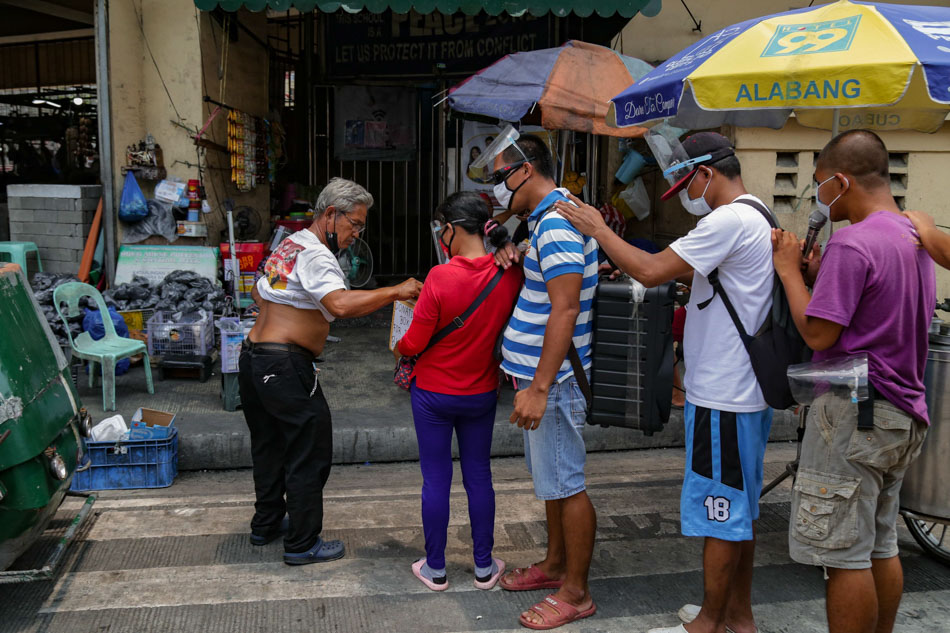 The group walks several streets hoping to cover as much area as they can. George Calvelo, ABS-CBN News