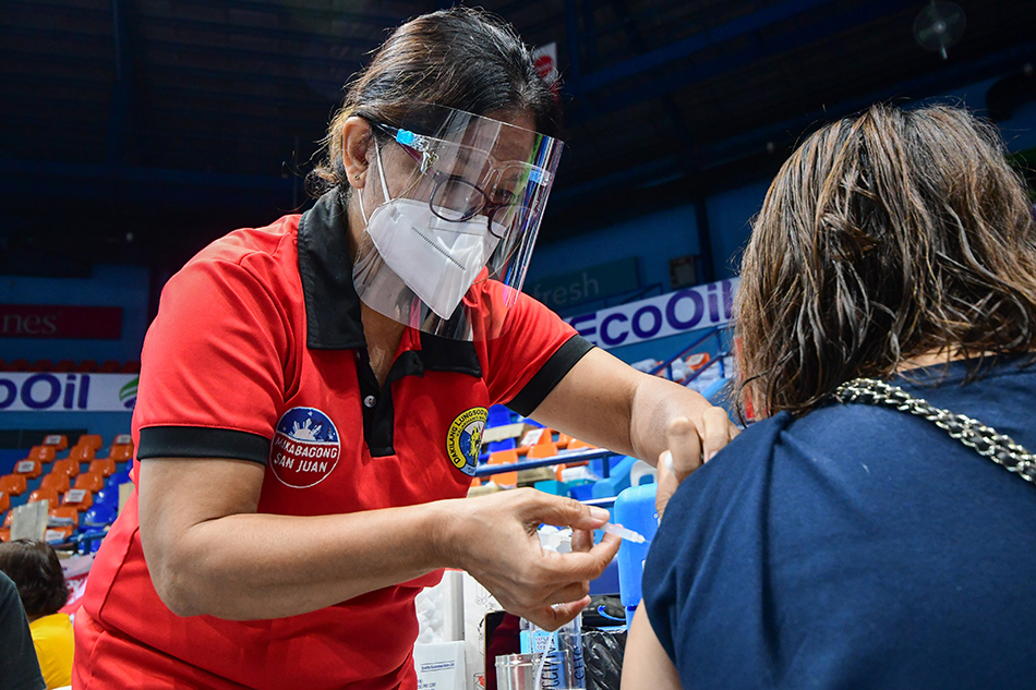 San Juan City residents and workers receive their COVID-19 vaccine dose on August 24, 2021. The MMDA says San Juan City will also open to inoculate those from other parts of Metro Manila soon as they complete vaccinating eligible residents and workers within the city. Mark Demayo, ABS-CBN News