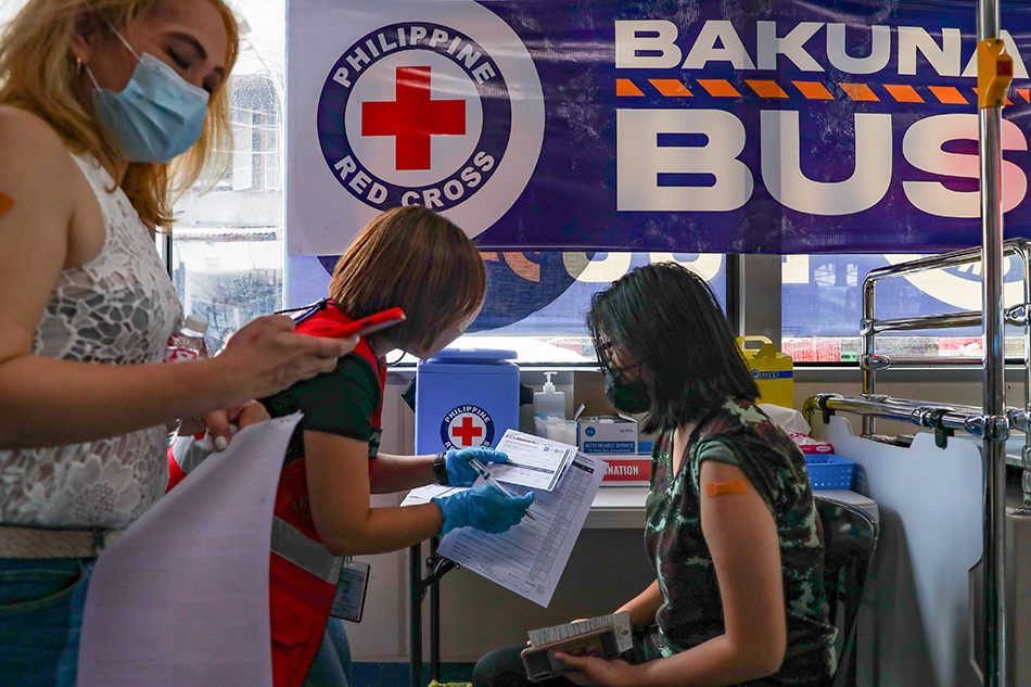 Students of University of the East receive their first dose of Astra Zeneca COVID-19 vaccine at the Bakuna Bus (Vaccine Bus) by the Philippine Red Cross (PRC) in Manila on Nov. 18, 2021. Jonathan Cellona, ABS-CBN News