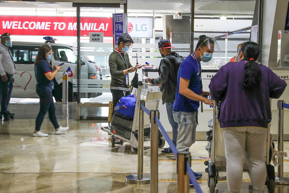  Overseas Foreign Workers (OFWs) arrive at the lobby of the Ninoy Aquino International Airport (NAIA) Terminal 1 in Parañaque City on July 01, 2021. Jonathan Cellona, ABS-CBN News 