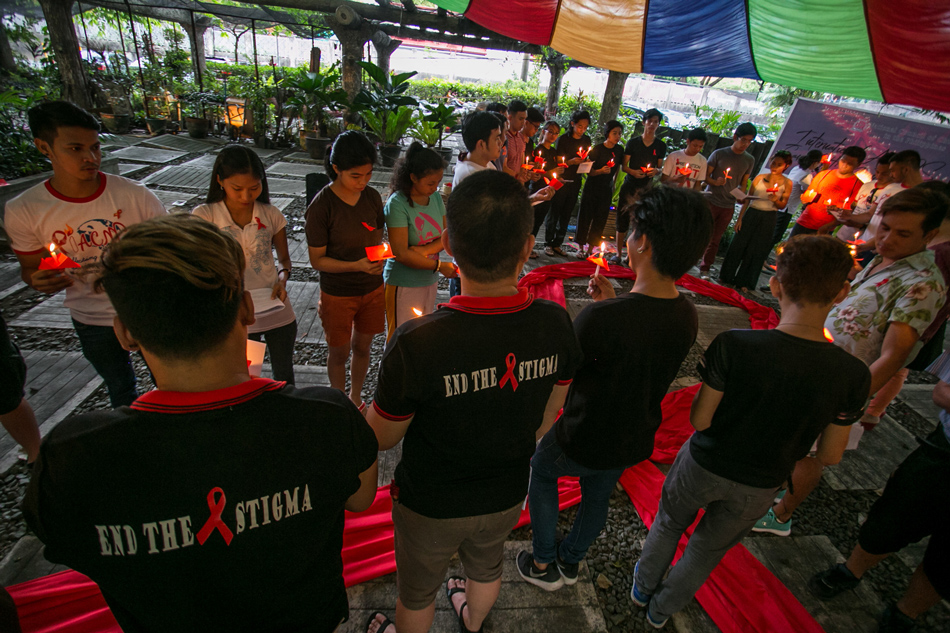 Church groups and health advocates light candles to honor and remember people who died of HIV/AIDS in observance of the International AIDS Candlelight Memorial in Quezon City on May 21, 2018. Mark Saludes, ABS-CBN News.