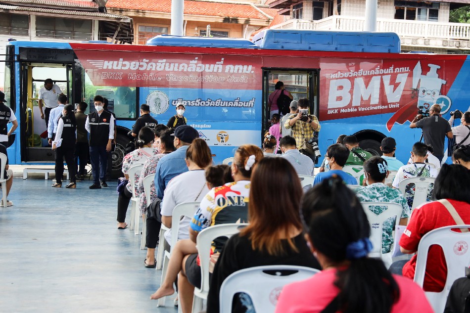 People wait in front of a coronavirus disease mobile vaccination bus set up to serve the elderly and disabled groups in Bangkok, September 8, 2021. Juarawee Kittisilpa, Reuters