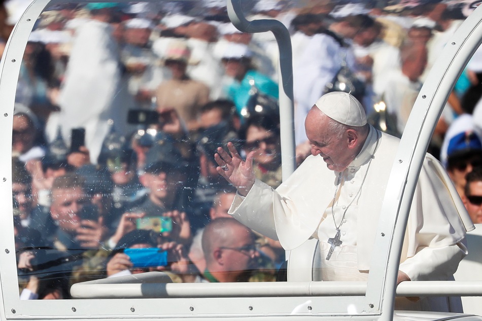 Pope Francis greets people as he arrives in Heroes