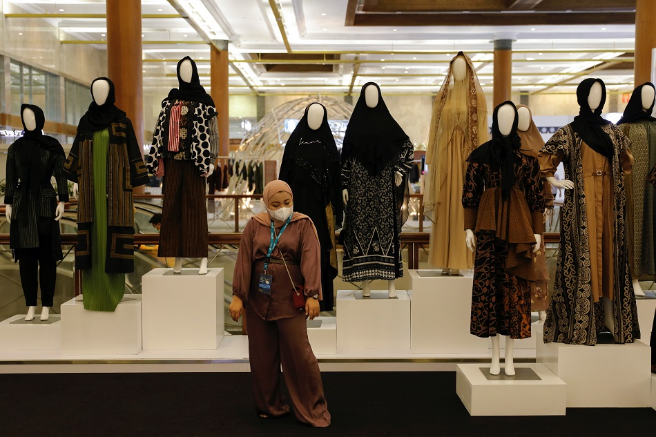 A woman stands among mannequins as she poses for pictures during Indonesia Sharia Economic Festival that held amid the COVID-19 pandemic in Jakarta, October 28, 2021. Willy Kurniawan, Reuters