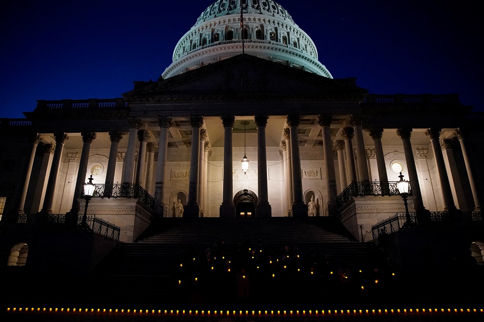 Bipartisan members of the House and Senate hold a moment of silence for the more than 800,000 American lives lost to COVID-19 outside the US Capitol building in Washington, December 14, 2021. Elizabeth Frantz, Reuters