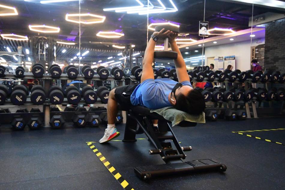 Customers exercise with masks on at a gym located inside a mall in Mandaluyong City on June 16, 2021. Mark Demayo, ABS-CBN News/File