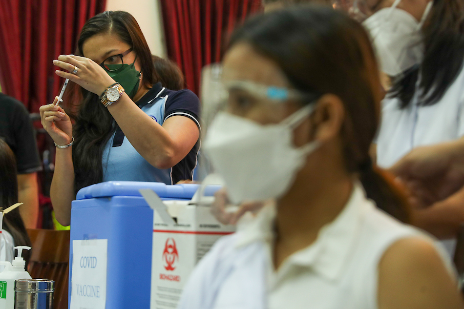 College students of Our Lady of Fatima University Pampanga are inoculated against COVID-19 at the campus on Oct. 13, 2021. Jonathan Cellona, ABS-CBN News