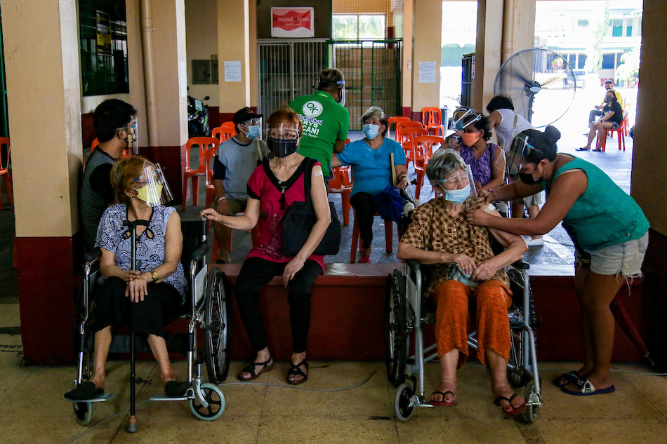 Elderly citizens receive their second dose of Moderna’s COVID-19 vaccine inside the Ramon Magsaysay High School in Manila on Sept. 4, 2021. George Calvelo, ABS-CBN News/File