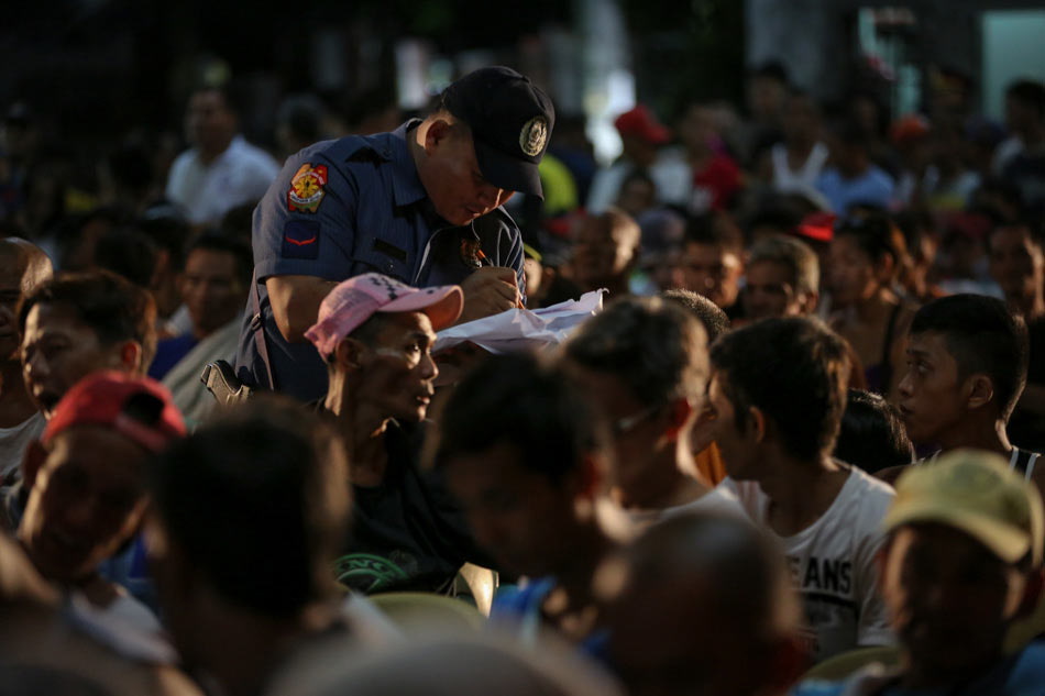 A police officer lists down names of suspected drug users and pushers at a processing center in Tondo, Manila. File Photo/Jonathan Cellona, ABS-CBN News