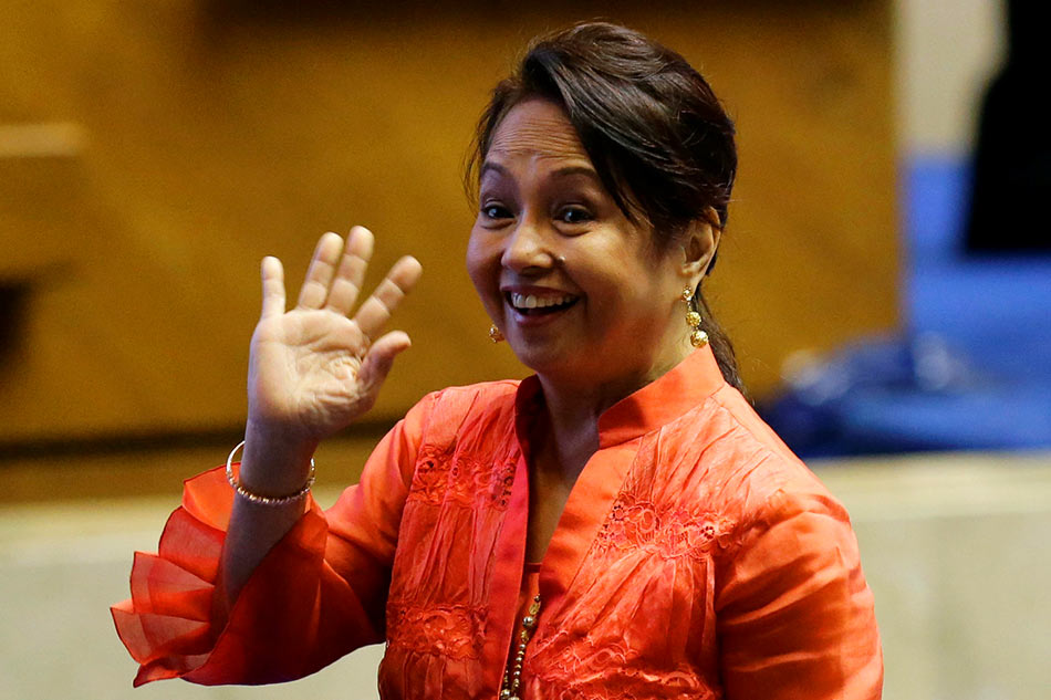 Former president and new House Speaker Gloria Macapagal-Arroyo waves during the third session of the 17th Congress ahead of President Rodrigo Duterte's state of the nation address on July 23, 2018. Noel Celis, AFP/file