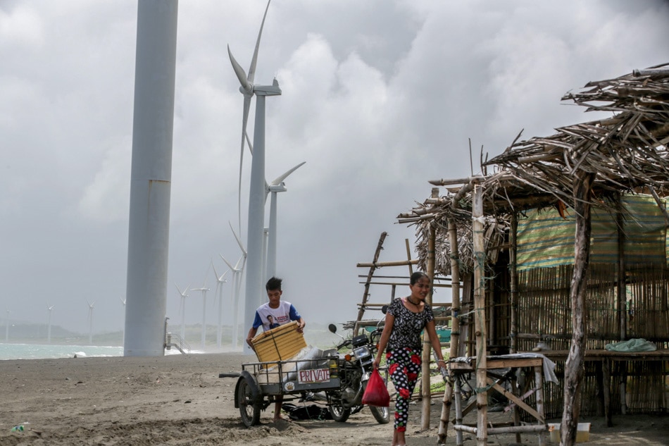 Resident and shop owners secure their products at the Bangui Wind Farm on Sept. 18, 2022. Jonathan Cellona, ABS-CBN News/File