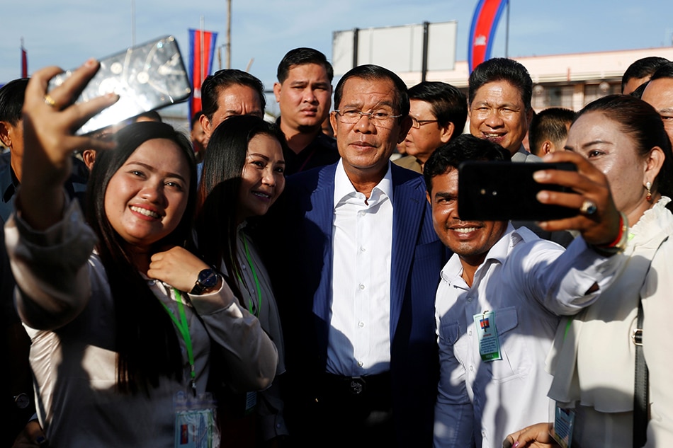 Image result for Cambodia's Hun Sen takes selfies in first appearance since controversial election