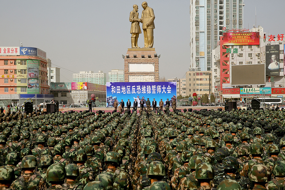 This photo taken on February 27, 2017 shows Chinese military police attending an anti-terrorist oath-taking rally in Hetian, northwest China