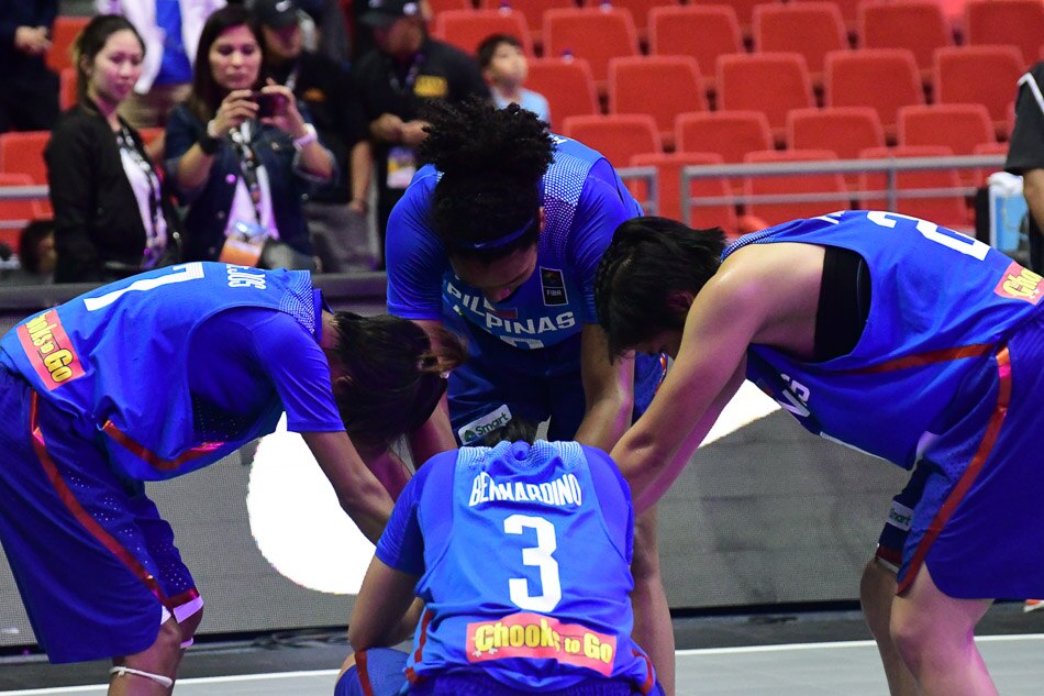 the philippine women's team huddles after their loss to