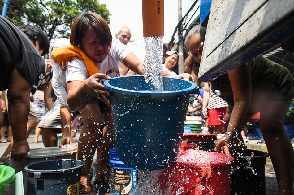 Residents line up during a water distribution drive in Mandaluyong. Mark Demayo, ABS-CBN News/file