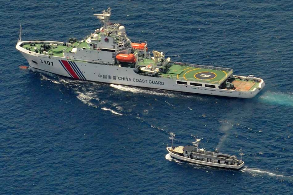 A China Coast Guard ship (top) and a Philippine ship engage in a stand off as the Philippine boat attempts to reach the Ayungin Shoal in the West Philippine Sea on March 29, 2014. The Philippine ship slipped past the Chinese blockade to reach the shoal where a grounded ship, BRP Sierra Madre, is stationed. Jay Directo, AFP/File​