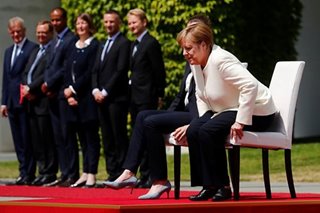 Merkel sits through anthems after shaking spells