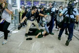WATCH: Passengers run for cover as police arrive at Hong Kong airport
