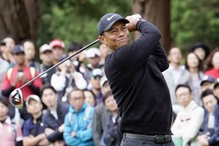 Golf: Tiger Woods shoots second 64, leads by two in rain-hit Japan