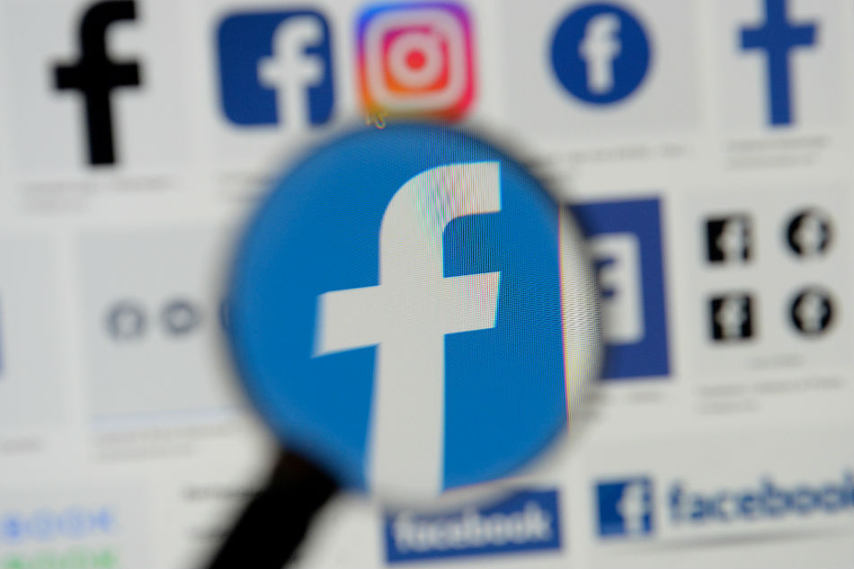 Facebook logos are seen on a screen in this