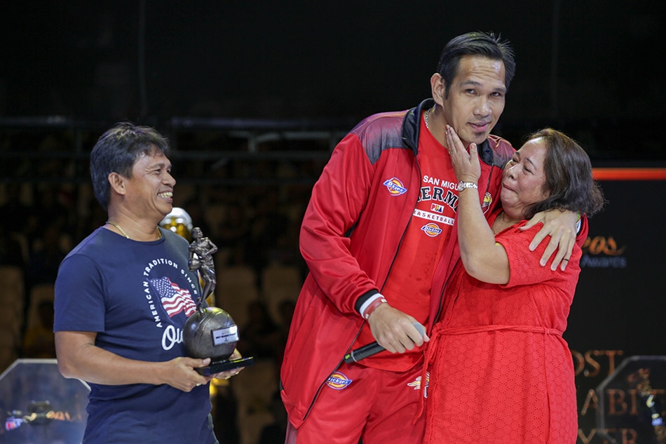 June Mar Fajardo is joined on stage by his parents after receiving the MVP trophy. File photo.