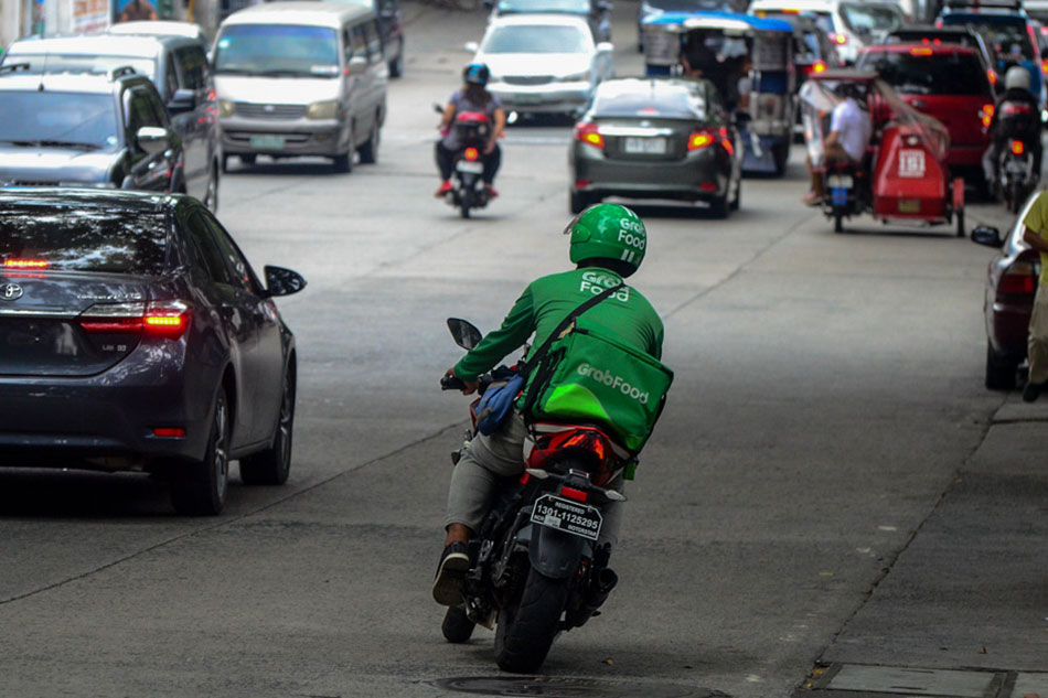 A GrabFood rider leaves for a delivery in Quezon City. Mark Demayo, ABS-CBN News/File