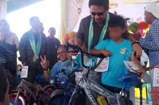 'Children of war' swap toy guns for bicycles, stuffed toys, school supplies