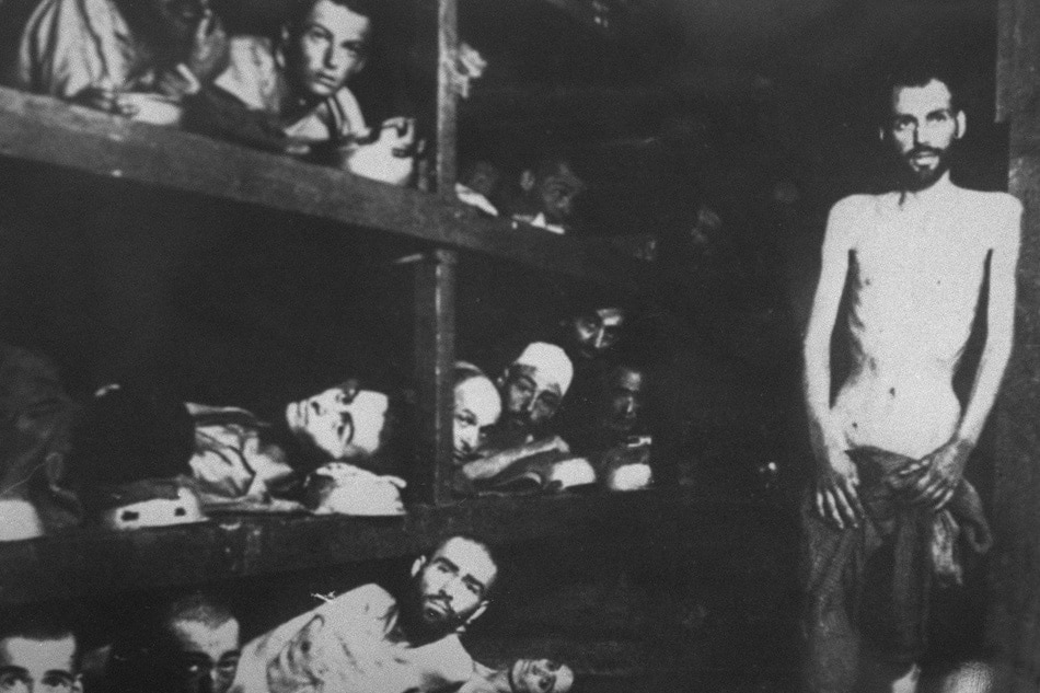 Jewish deportees in the Buchenwald concentration camp pose for a Soviet photographer when the Red Army re-staged the liberation of the Nazi's concentration camp a week after they first arrived 27 January 1945 without any cameras. Middle bunk bed, the 6th from left, lies Elie Wiesel, one of the rare camp survivors and 1986 Nobel Peace prize winner. The Jews in Europe who escaped the Nazi holocaust were herded into refugee camps and some with organized Zionist help tried to reach Palestine. AFP