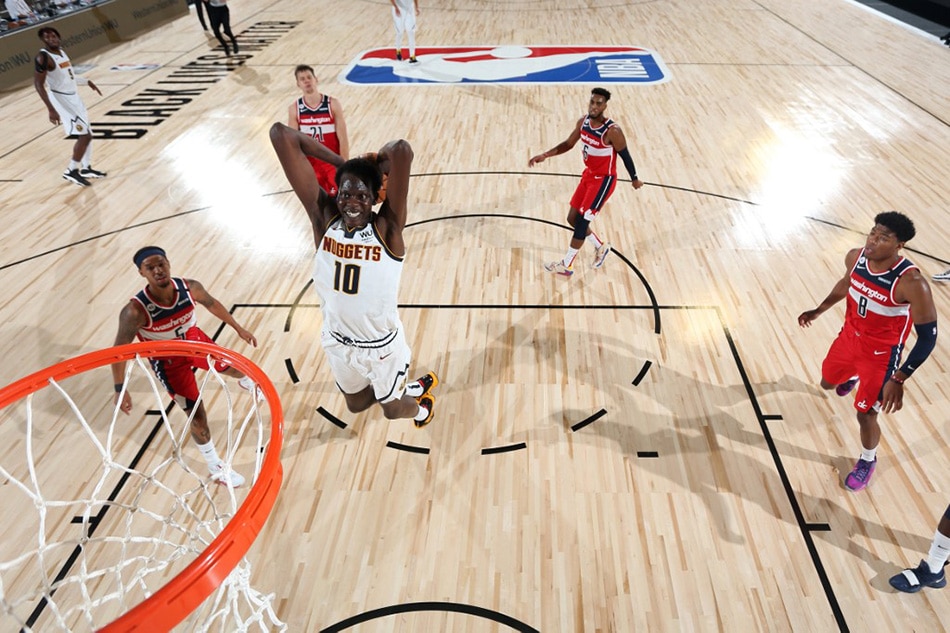 Bol Bol (10) of the Denver Nuggets drives to the basket against the Washington Wizards during a scrimmage on July 22, 2020 at The Arena at ESPN Wide World of Sports in Orlando, Florida. David Dow, NBAE via Getty Images/AFP