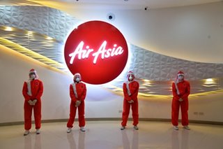 LOOK: AirAsia debuts protective suits against COVID-19 for flight crew