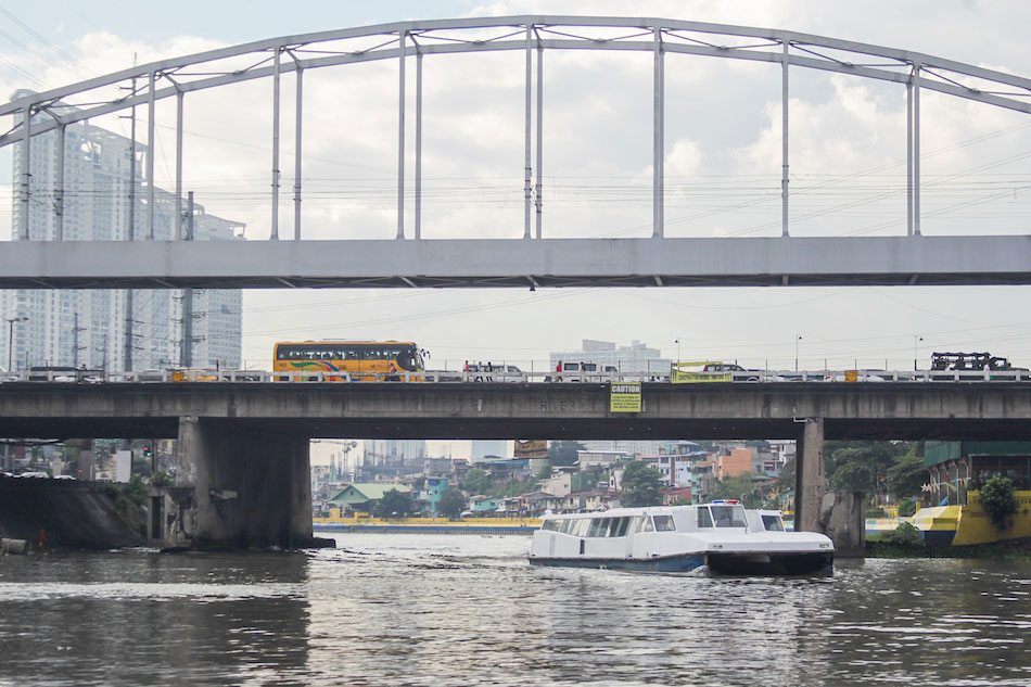 A passenger ferry crosses the Pasig River.