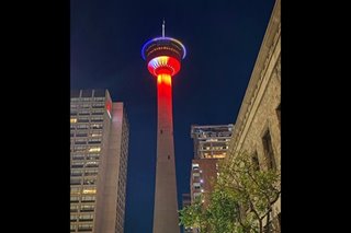 Canada's Calgary Tower lit up with colors of Philippine flag
