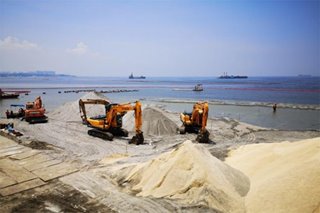 DENR dumps synthetic white sand on baywalk as part of Manila Bay rehab