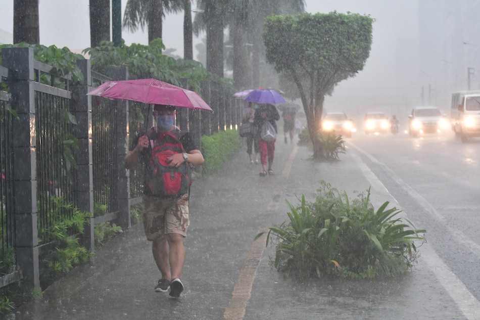 Rain pours on pedestrians in Quezon City on Oct. 11, 2020. Mark Demayo, ABS-CBN News/File