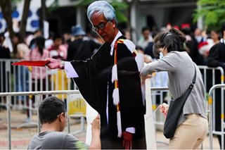 Thai students pose with 'dissidents' in graduation protest