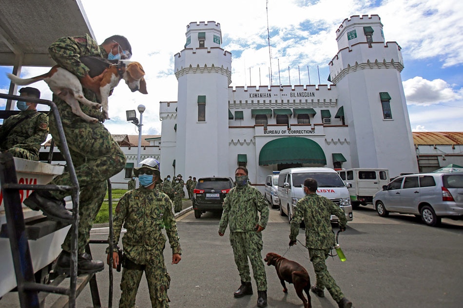 Members of the Philippine National Police K-9 team wait for go-signal to conduct clearing operations at the New Bilibid Prisons in Muntinlupa City on Nov. 10, 2020, after a riot broke out in the national penitentiary. ABS-CBN News/File 