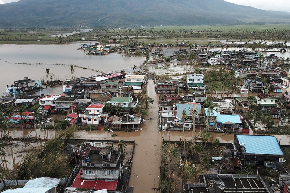 An aerial view shows destroyed and flooded houses after super Super Typhoon Rolly hit the town of Malinao, Albay province, south of Manila on Nov. 1, 2020. Charism Sayat, AFP/File