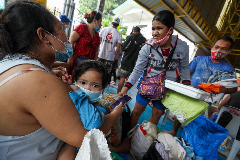 Residents take shelter at the NIA Village covered court after a fire razed their community in Barangay Sauyo in Quezon City on Nov. 27, 2020 amid the COVID-19 pandemic. Jonathan Cellona, ABS-CBN News/File