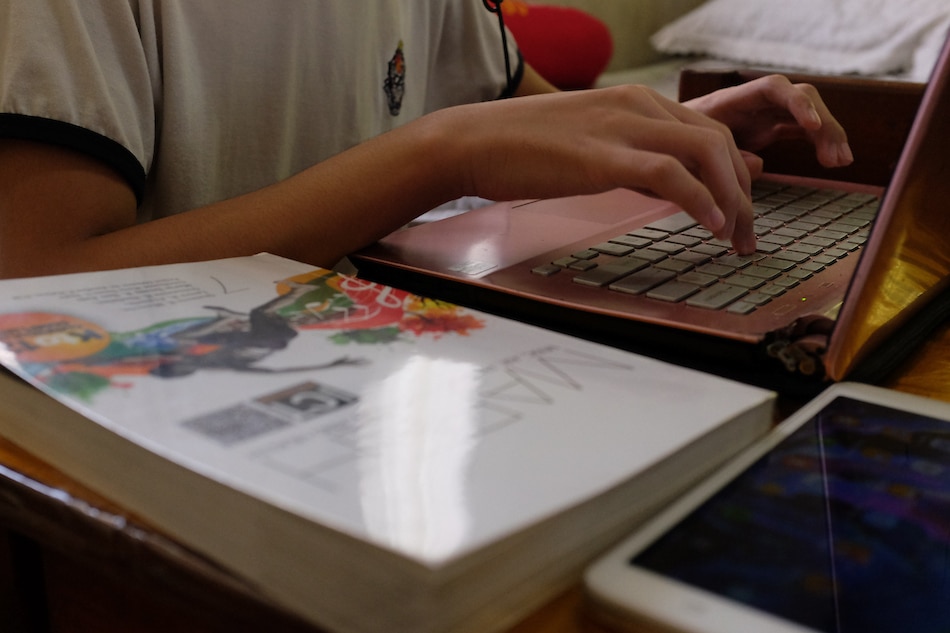 Students take part in their online classes inside their home in Parañaque on September 24, 2020. George Calvelo, ABS-CBN News