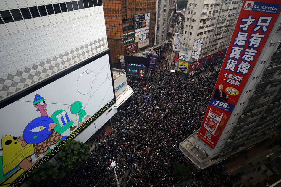 Thousands march in Hong Kong on New Year's Day, pledge to 'keep ...