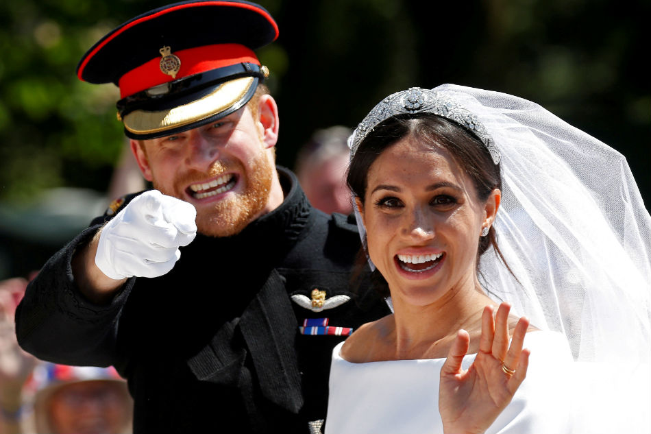 Britain&#39;s Prince Harry and Meghan to give up royal titles 1