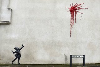 Banksy plays with violence and innocence in Valentine's Day graffiti