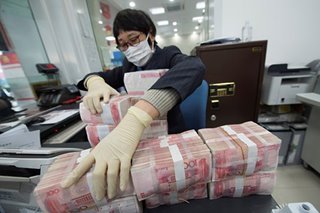 China cleans, locks away banknotes to stop virus spread