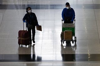 China cuts international flights, bars foreign residents