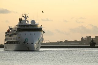 Crew from virus-hit liner disembark in Uruguay