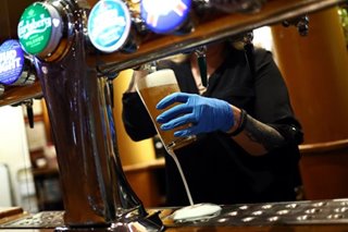 ‘I couldn’t wait’: Beer flows again in England’s pubs