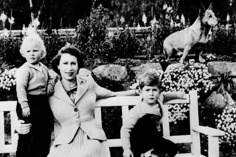 Queen Elizabeth with her children, Anne and Charles, and a corgi, at Balmoral in Scotland. AFP