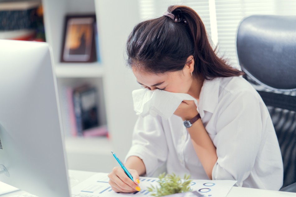 Photo source: iStock [LINK OUT: https://www.istockphoto.com/photo/women-are-sneezing-and-are-cold-she-is-in-the-office-gm947805434-258783491