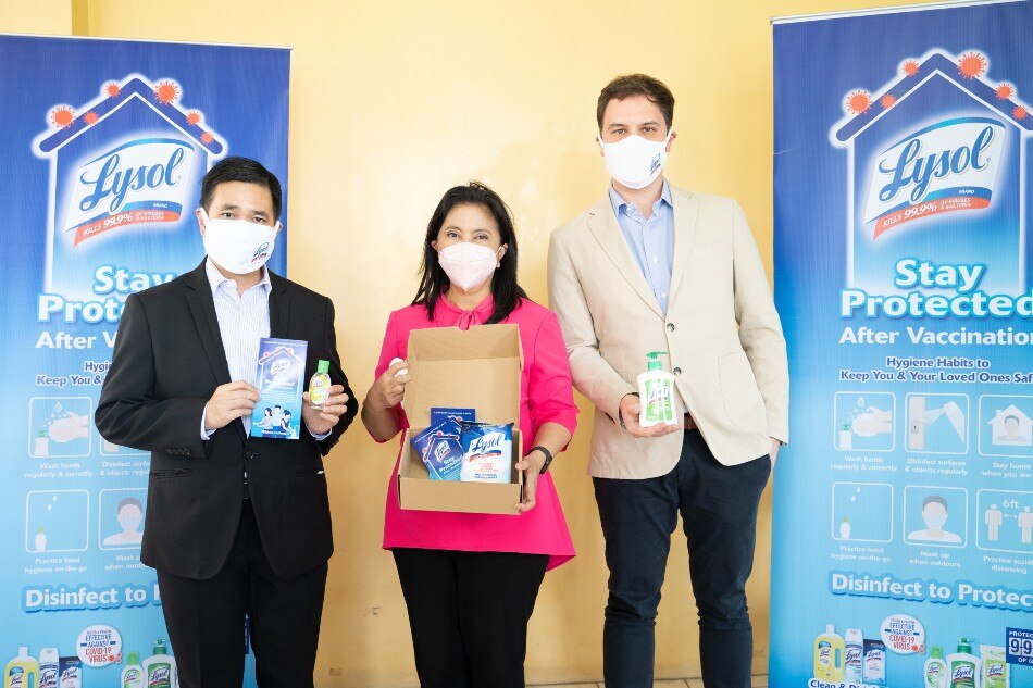 Shown in the photo are Lysol Philippines' representatives Alfred So, Regulatory Affairs and Policy Director (leftmost), and Matt Davis, Marketing Director (rightmost) with Vice President Leni Robredo (center). The brand recently donated hygiene kits in support of the Vaccine Express Program of the Vice President. Photo source: Lysol